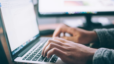 Person Typing On Macbook