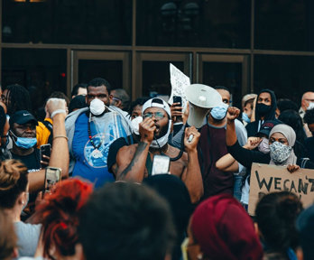 Crowd of protesters holding signs.