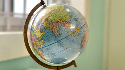 A blue globe on a brass stand,