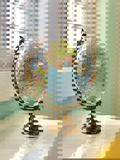 A blue globe on a brass stand