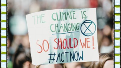Climate action protest sign reading 'the climate is changing, so should we! Act now'.
