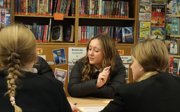 Three students at a table participate in a workshop.