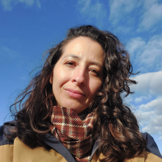 Carina De Araujo against blue sky background.