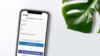 LinkedIn app registration page open on phone on the left of a green leaf.