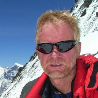 Chris Imray with a snowy, mountainous landscape in the background.