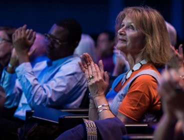 Audience applauding in a lecture theatre.
