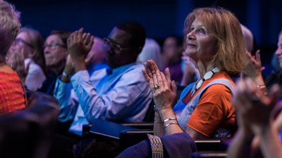 Audience applauding in a lecture theatre.