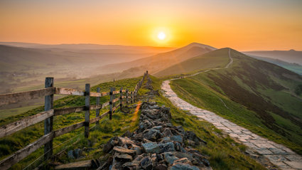 Sunrise over the Great Ridge at Mam Tor hill in Peak District.