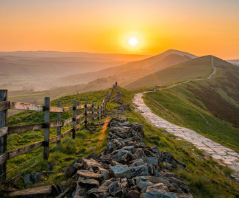 Sunrise over the Great Ridge at Mam Tor hill in Peak District.