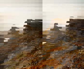 A view over the landscape of the Isle of Skye, showing craggy hills and valleys