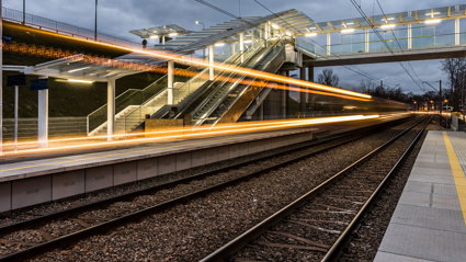 Long exposure photograph of train lights at a train station.