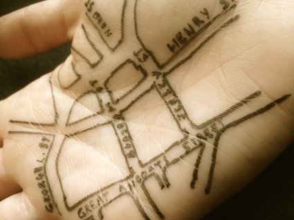 A hand painted with a line map of Liverpool streets