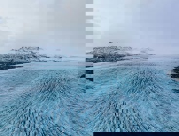 Large ice field with mountains in the background