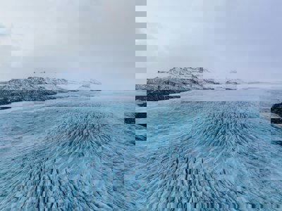 Large ice field with mountains in the background