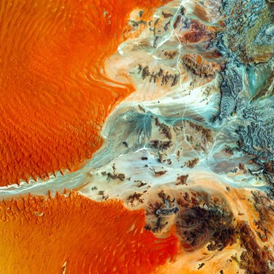 An aerial image of Earth showing oranges and blues