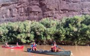People in two canoes in a canyon river.