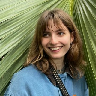 Headshot of Anna (Ania) Sawko against green background.