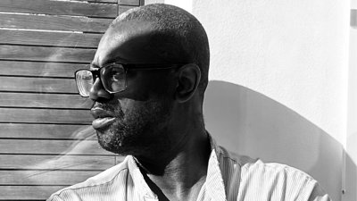 Black and white headshot of person.