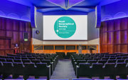 A stage-facing shot of the Ondaatje Lecture Theatre with blue lighting. 