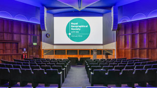 A stage-facing shot of the Ondaatje Lecture Theatre with blue lighting.