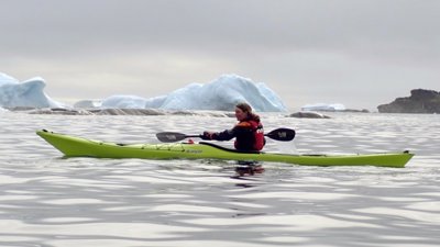Katherine Durkin in a kayak paddling through the fjords