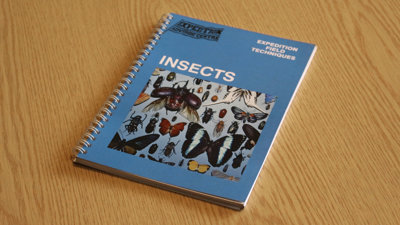 A copy of Expedition Field Techniques: Insects on a desk.