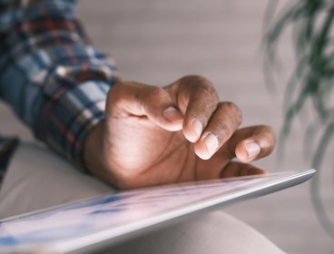 Person typing on a tablet 