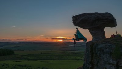 Extreme sleeper dangled off cliff edge during sunset.