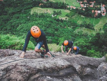Three people mountain climbing in West Java.