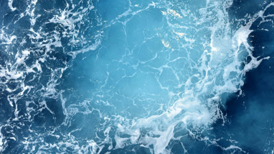 Blue sea with foamy white waves.