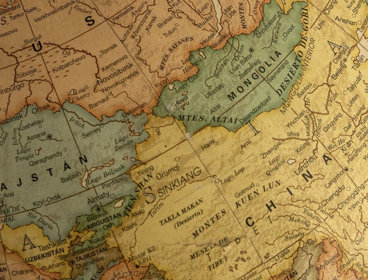 Close-up of a vintage globe highlighting Asia and Europe with detailed old-fashioned map design.