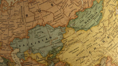 Close-up of a vintage globe highlighting Asia and Europe with detailed old-fashioned map design.