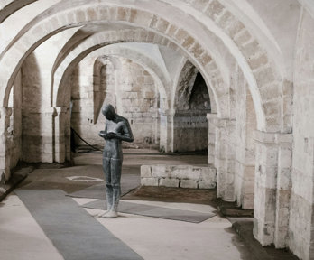 Statue Of Person Holding Bowl In Church