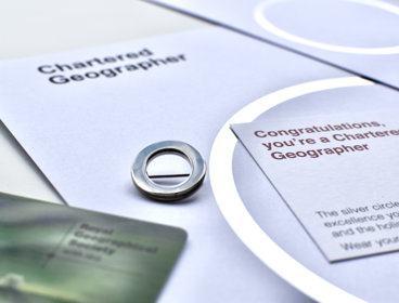 Chartered Geographer silver circle pin, card reading "Congratulations, you're a Chartered Geographer" and 2023 membership card