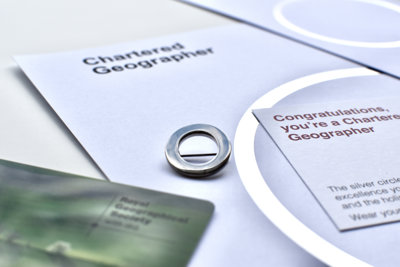 Chartered Geographer silver circle pin, card reading "Congratulations, you're a Chartered Geographer" and 2023 membership card