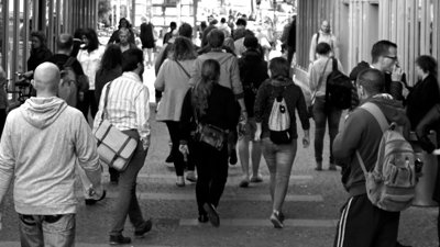 A crowd of people walking down a busy street.
