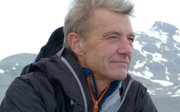 Headshot of Paul Rose with snowy mountains in the background.