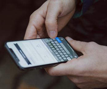 A person texts on their smartphone.
