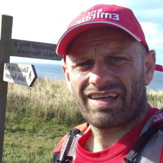 Paul Burgum taking a selfie near the sea.