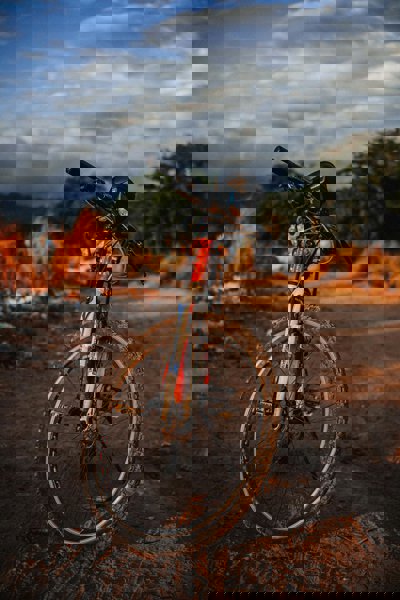 A mountain bike stood on a dirt road