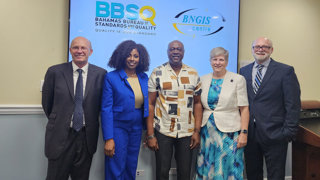 Group of people standing in front of a screen that reads Bahamas Bureau of Standards and Quality.