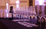A close-up shot of wine glasses set-up on a formal bar. 