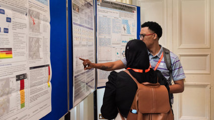 A presenter discussing their poster with another conference attendee.