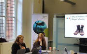 Two researchers in a workshop at the society, with laptops on the table