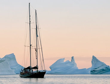 A boat sailing through icebergs.