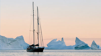 A boat sailing through icebergs.
