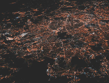 Aerial view of city lights in the dark.