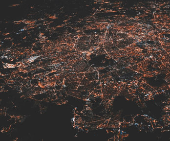 Aerial view of city lights in the dark.