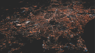 Aerial view of city lights in the dark.