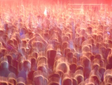 Blurred crowd at a festival with an orangey glow